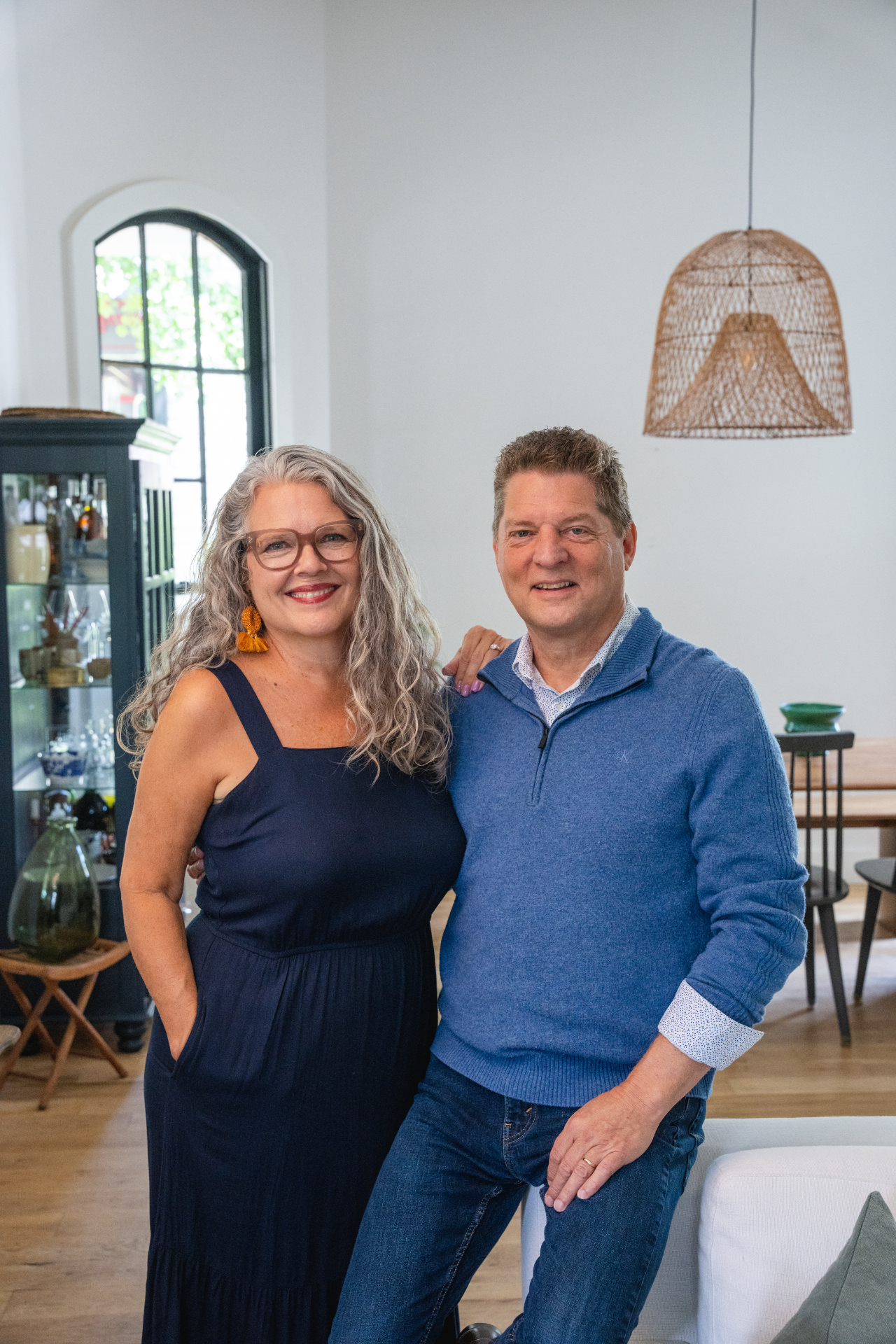 Glenn and Phyllis smiling together in a bright living room